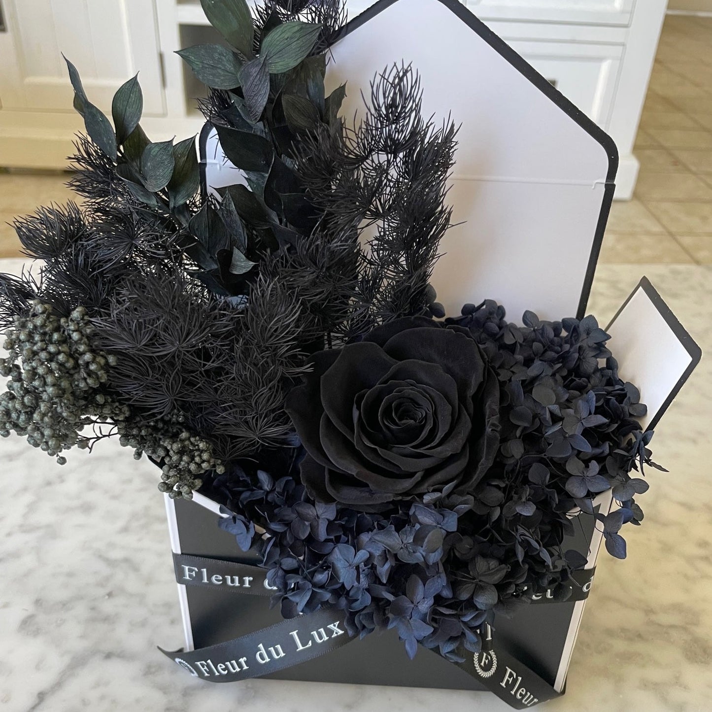 black everlasting roses in envelope 