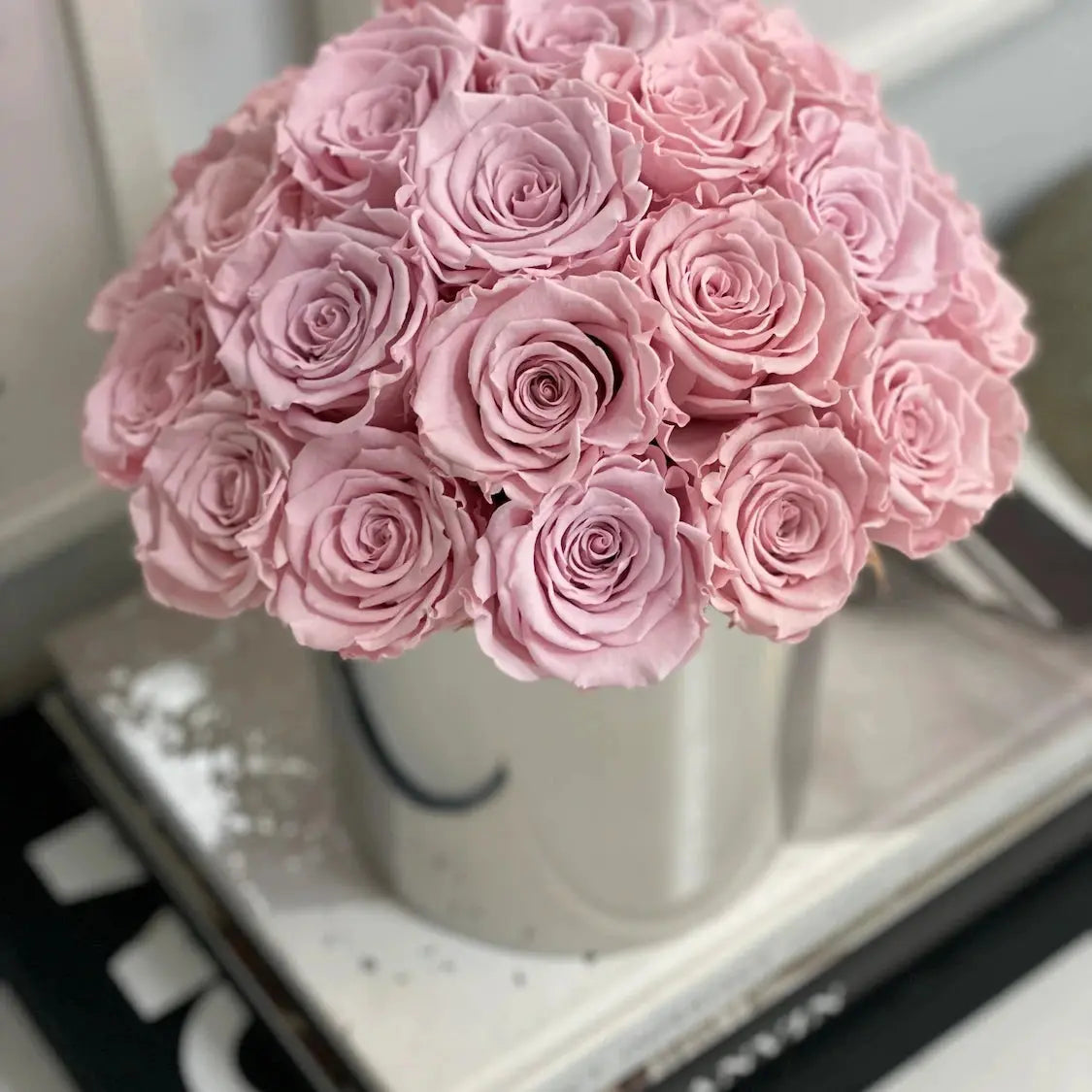 verlasting pale pink preserved roses arranged in a stainless steel pot