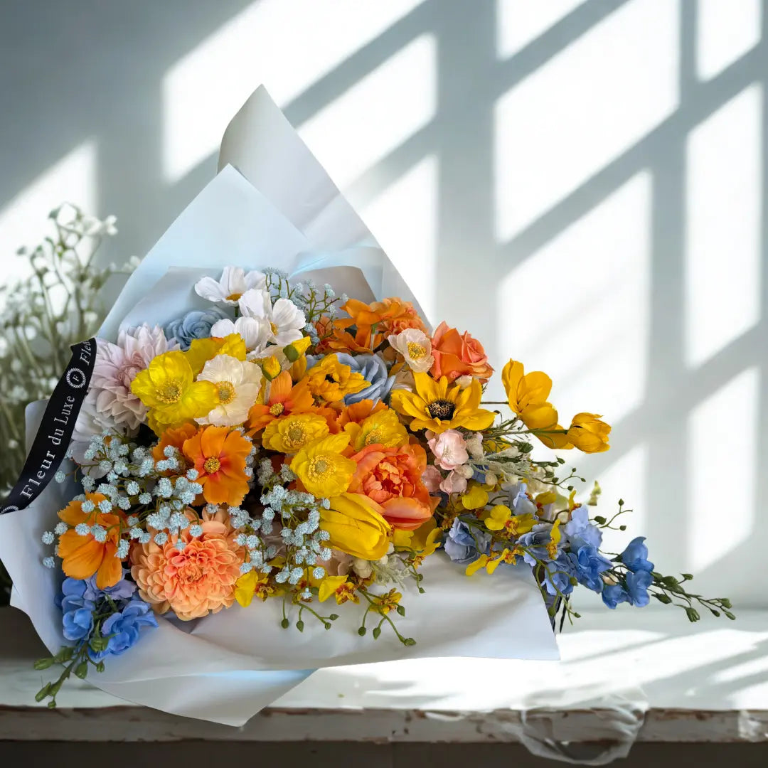Colorful bouquet of flowers on a white surface with a blurred background