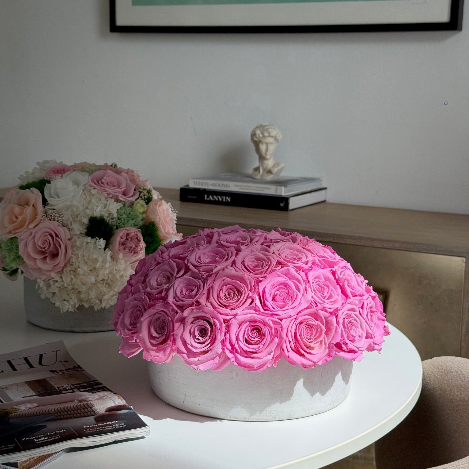 Dining room with Fleur du Luxe preserved rose arrangement as centerpiece.