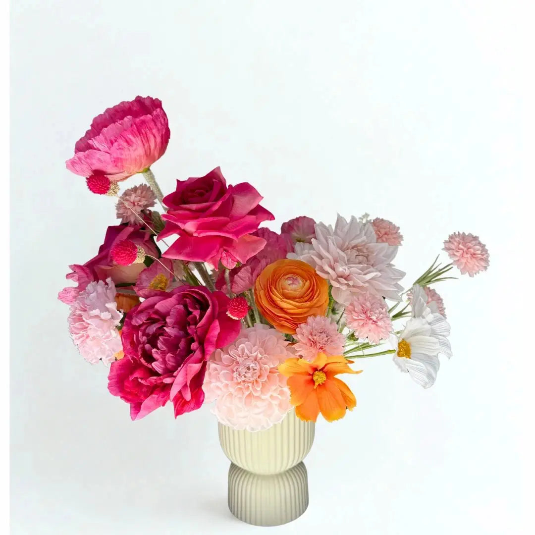 Bouquet of colorful flowers in a vase on a white background